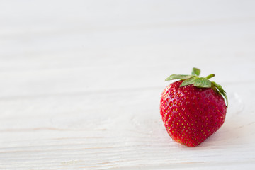 Strawberries ripe on a white wooden background. Copy space. Healthy lifestyle concept
