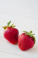Strawberries ripe on a white wooden background. Copy space. Healthy lifestyle concept