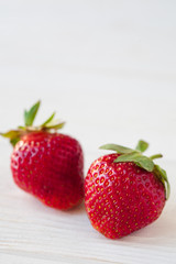 Strawberries ripe on a white wooden background. Copy space. Healthy lifestyle concept