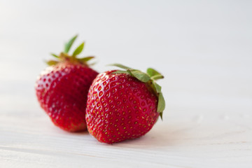 Strawberries ripe on a white wooden background. Copy space. Healthy lifestyle concept