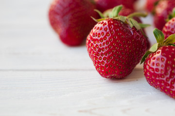 Strawberries ripe on a white wooden background. Copy space. Healthy lifestyle concept