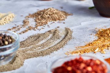 Assortment of ground powder spices on white background, top-view, close-up, macro, shallow depth of field