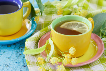 Cups of herbal tea with linden blossoms and lemon