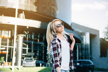 Young stylish pretty woman with sunglasses  posing in the city streets. vacation europe.