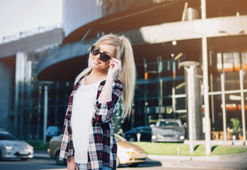 Fototapeta premium Young stylish pretty woman with sunglasses posing in the city streets. vacation europe.