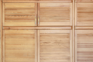 Modern wooden cabinet in classic rustic style. Details of wardrobe case with shutter plank doors. Country house interior