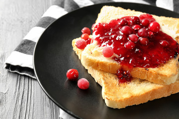 Plate with tasty sweet toasts on table, closeup