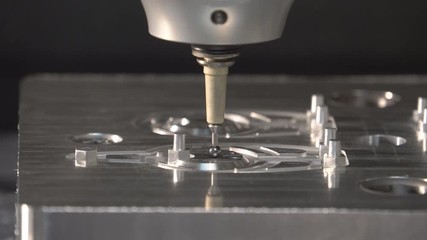 Metalworking at the factory. The computer-controlled machine cuts the part out of aluminum. Machine with program control 4k