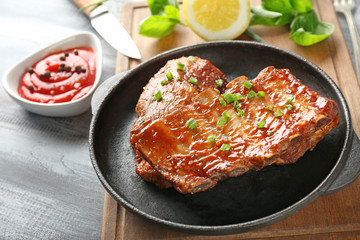 Frying pan with delicious ribs on board