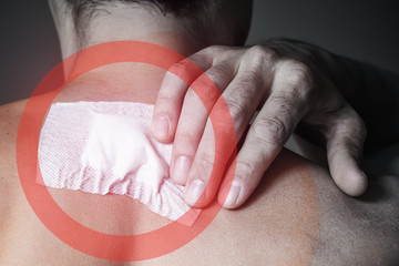 A wound stuck on the back of a man after removal of a fibroma, a birthmark. Close-up, toned