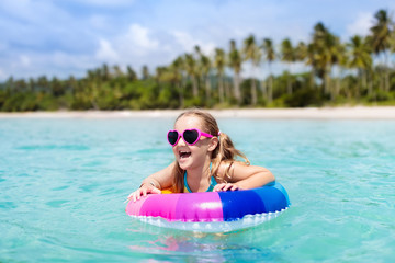 Child on tropical beach. Sea vacation with kids.