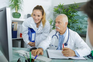 a photo of young medical team checking patients xray