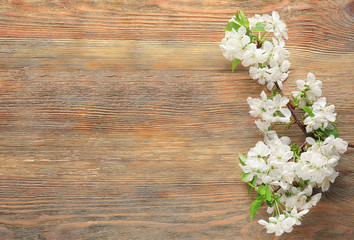 Fototapeta na wymiar Beautiful blossoming branch on wooden background