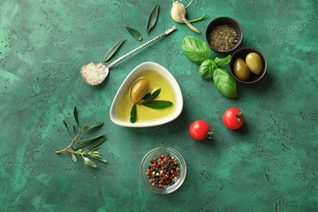 Composition with fresh olive oil on table