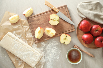 Ingredients for pastry with apples on table