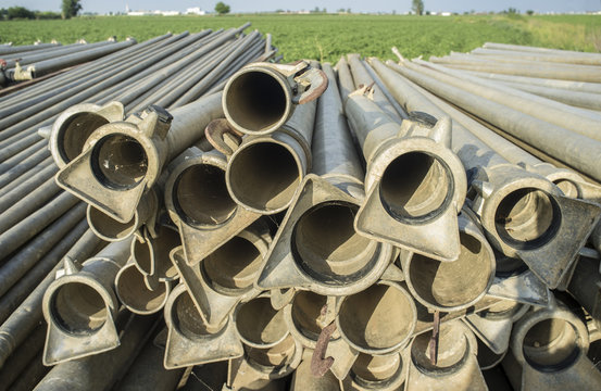 Irrigation metal pipes stacked outdoors out of watering season