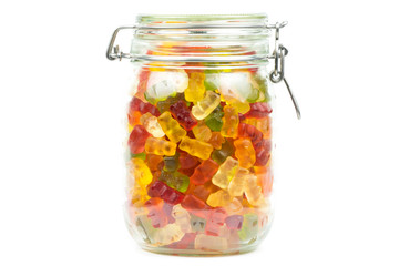 Colorful gummy bears / jelly baby candy sweets in a jar on a white background