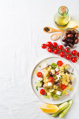 Pasta salad in a plate with ingredients