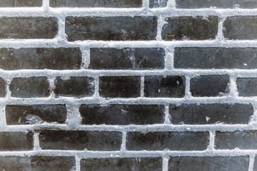 Black brick wall texture and background, toning, vignetting, blur.