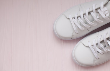 Overhead Shot Of White Sneakers On Pink Background