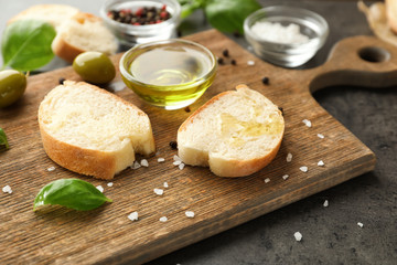 Bread and olive oil on grey table