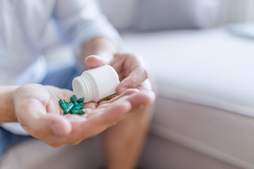 Man holding pills on hand