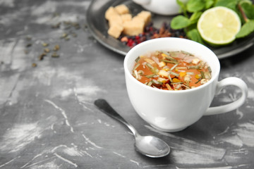 Cup of hot aromatic tea on table