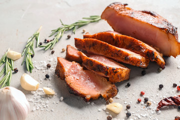 Sliced tasty steak with spices on light background