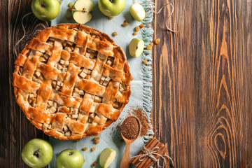 Composition with delicious apple pie on wooden table