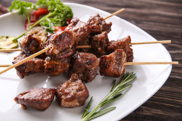 Barbecue skewers with juicy meat on plate