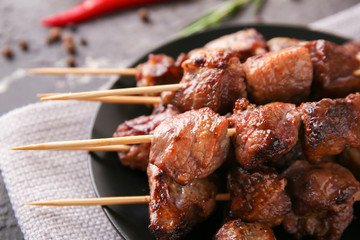 Barbecue skewers with juicy meat on plate