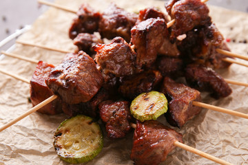 Barbecue skewers with juicy meat on parchment