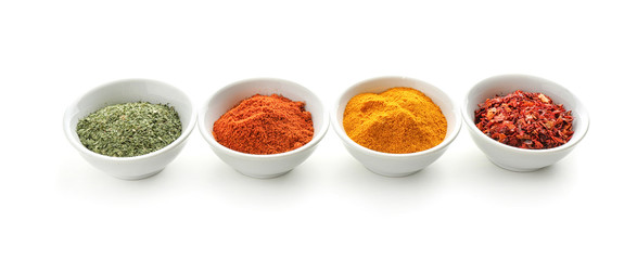 Bowls with various spices on white background