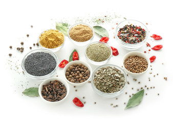 Bowls with various spices on white background