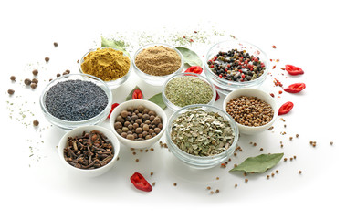Bowls with various spices on white background