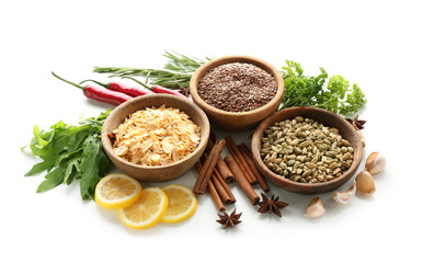 Bowls with various spices and herbs on white background