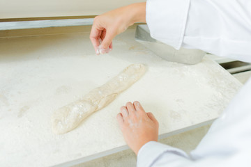 Dusting a baguette with flour