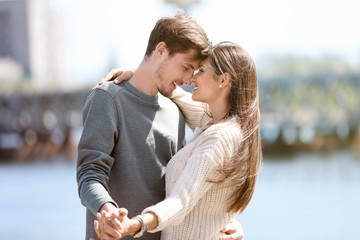 Happy young couple dancing outdoors