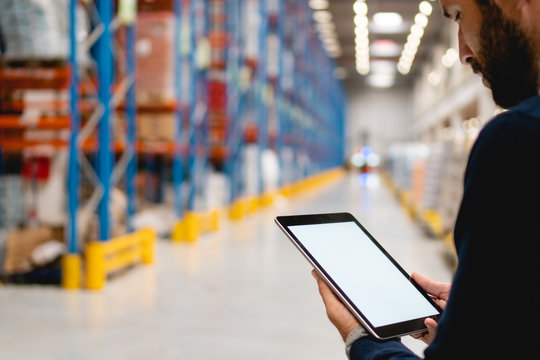 Manager holding digital tablet in warehouse