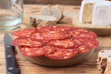 cheese and Iberian chorizo on rustic board