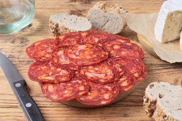 cheese and Iberian chorizo on rustic board