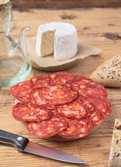 cheese and Iberian chorizo on rustic board