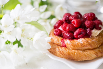 Spring mood. Blooming apple tree. Raspberry pie. Sweet cake with berries.