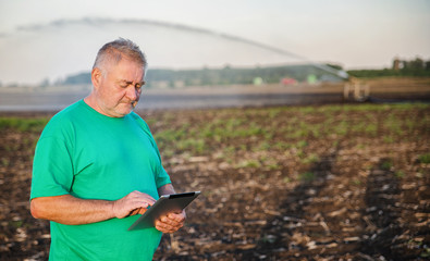 Farmer in a field with a tablet