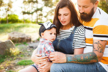 Hipster family, bearded dad with tattoos and stylish clothes.