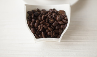Coffee cup full of coffee beans. roasted coffee beans, can be used as a background