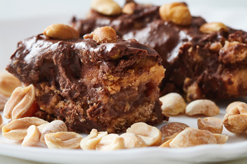 Homemade raw vegan chocolate candy bars. Dessert made with peanuts, cocoa butter, cashew and dates