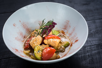 Assorted vegetables salad with sauce on wooden background