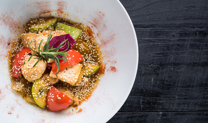 Assorted vegetables salad with sauce on wooden background