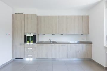 Light wood kitchen with white walls